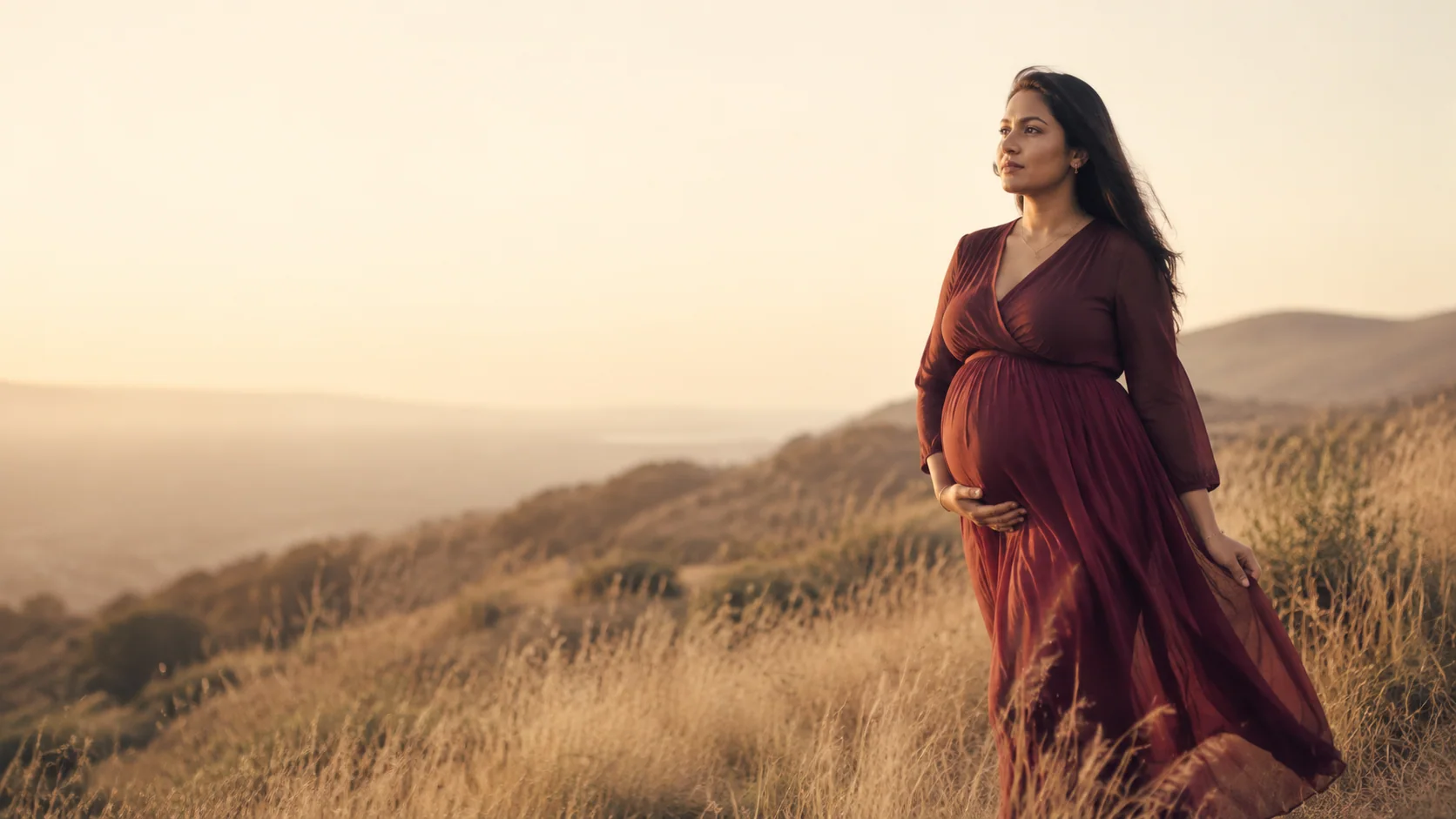 An expectant mother in a sunlit landscape